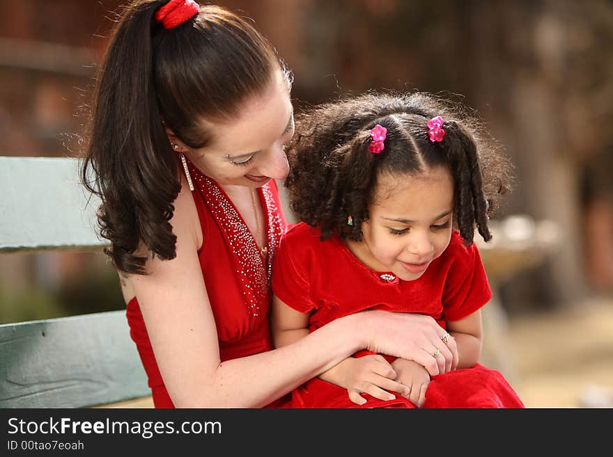 Beautiful multiracial child with afro hairstyle playing with her mother. Beautiful multiracial child with afro hairstyle playing with her mother