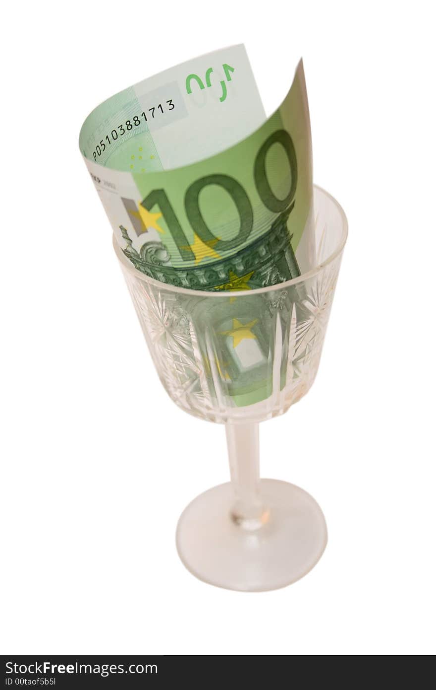 One 100 euro banknote in wineglass over white isolated background