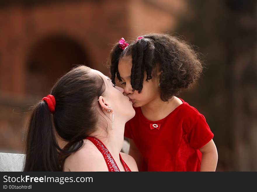 Beautiful multiracial childwith afro hairstyle playing with mother. Beautiful multiracial childwith afro hairstyle playing with mother