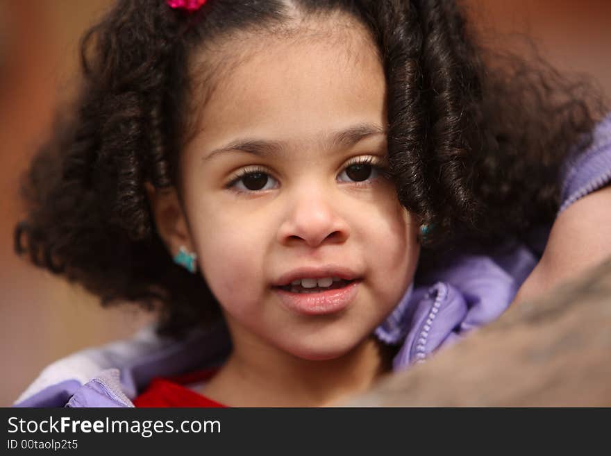 Beautiful multiracial child with afro hairstyle playing playing