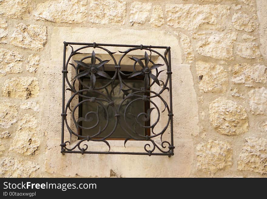 A fancy framed window in the street wall. A fancy framed window in the street wall