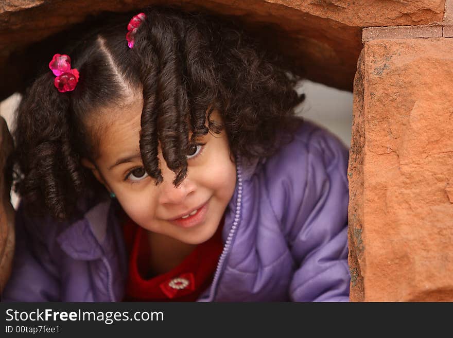 Beautiful multiracial child with afro hairstyle playing playing