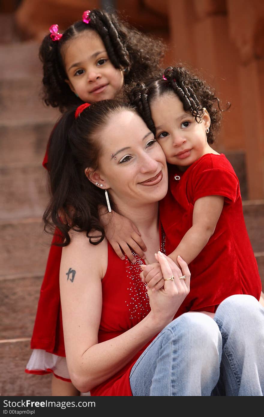 Beautiful multiracial children with afro hairstyle playing with mother. Beautiful multiracial children with afro hairstyle playing with mother