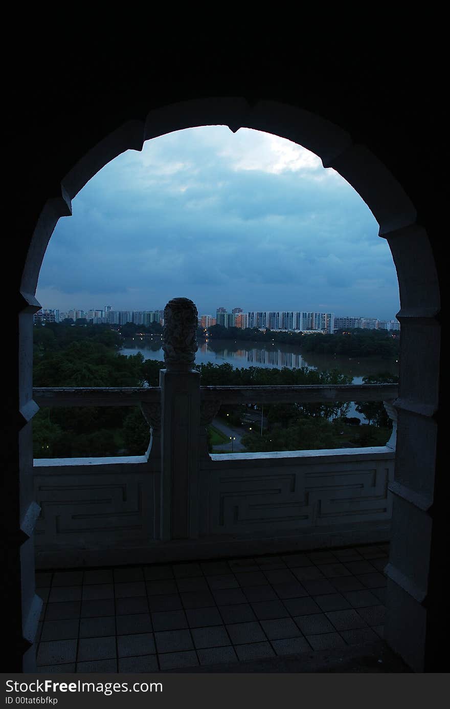 A view of building and sky through an arch door. A view of building and sky through an arch door