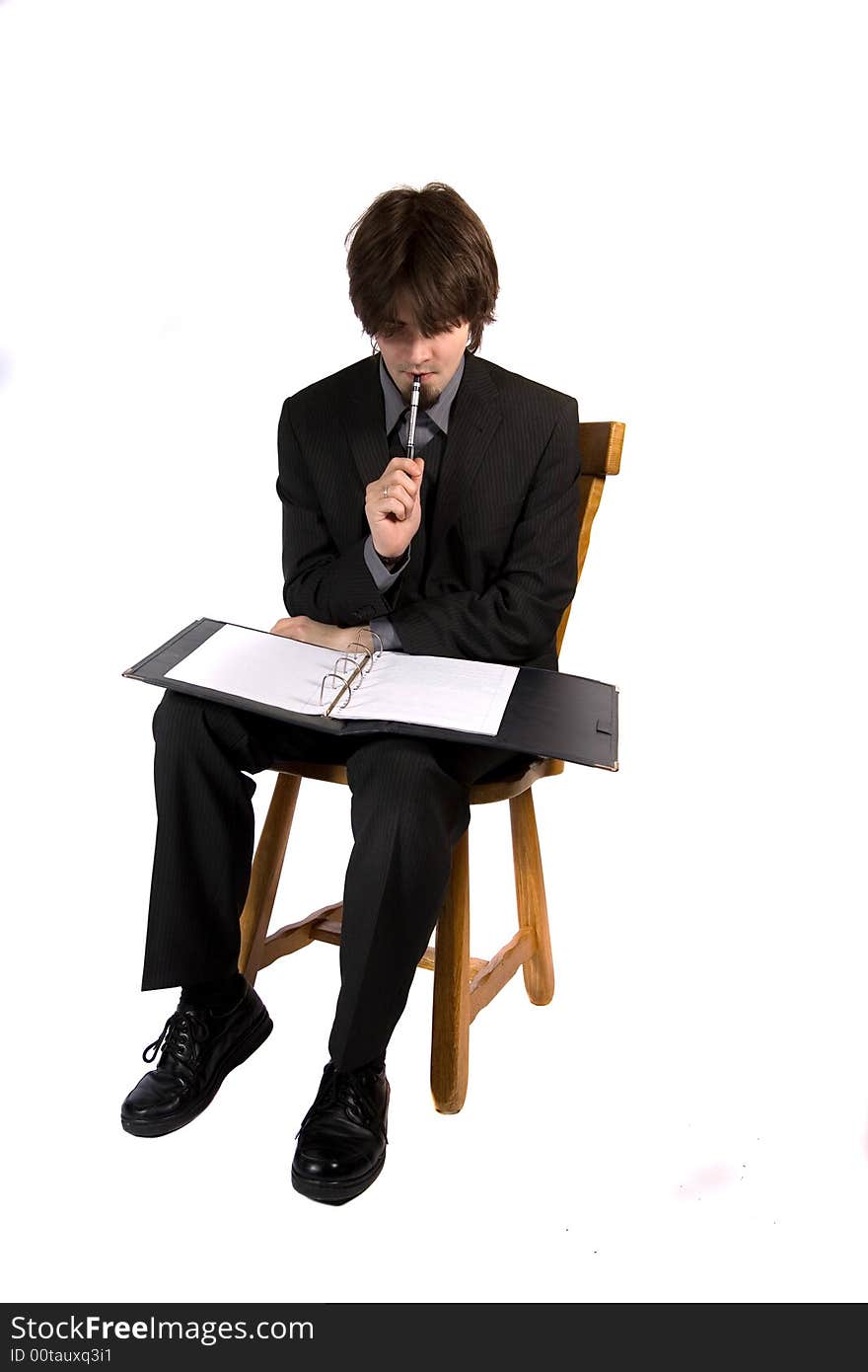 A young and pretty businessman sitting and working. A young and pretty businessman sitting and working