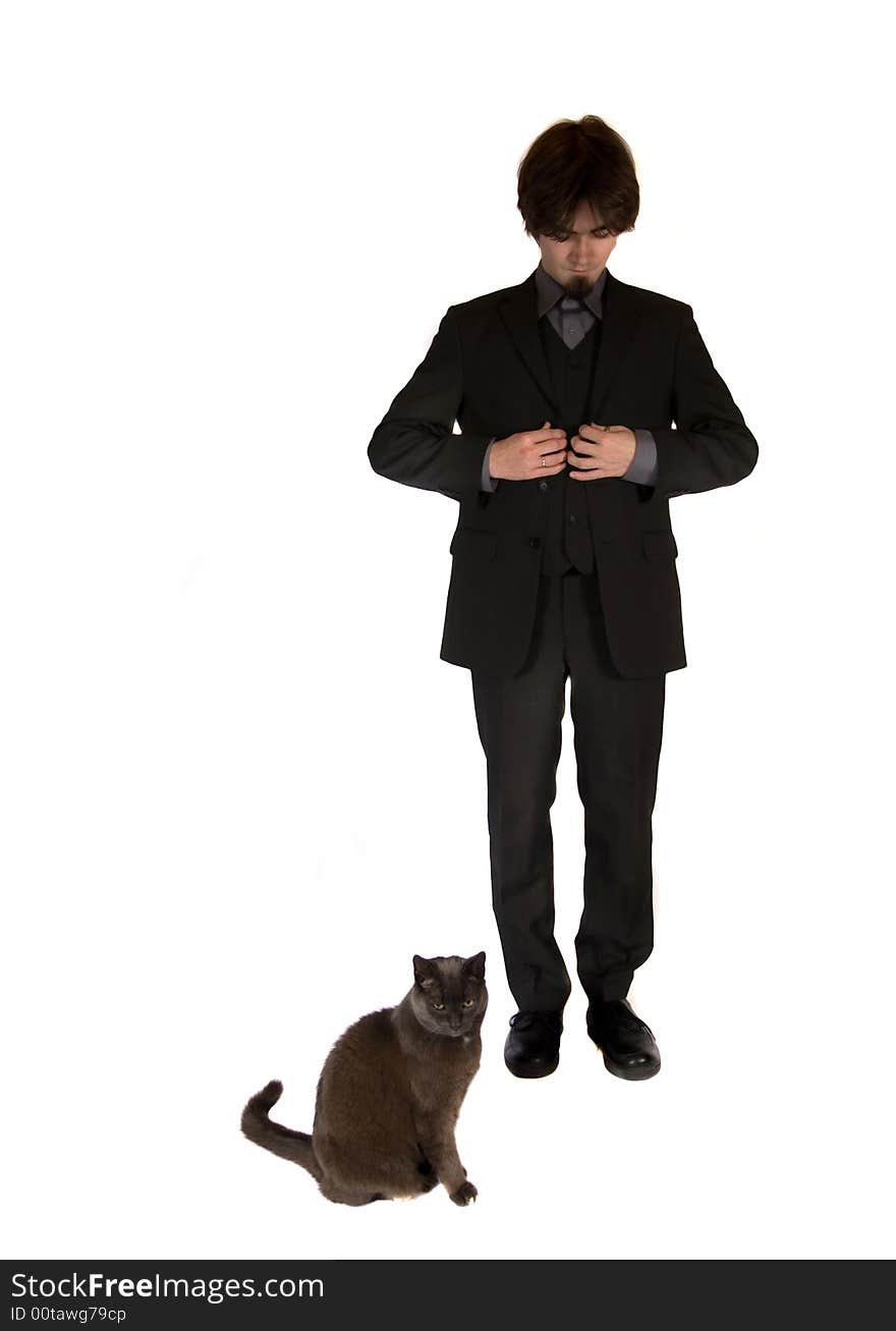 A young and pretty businessman standing next to a cute black cat. A young and pretty businessman standing next to a cute black cat