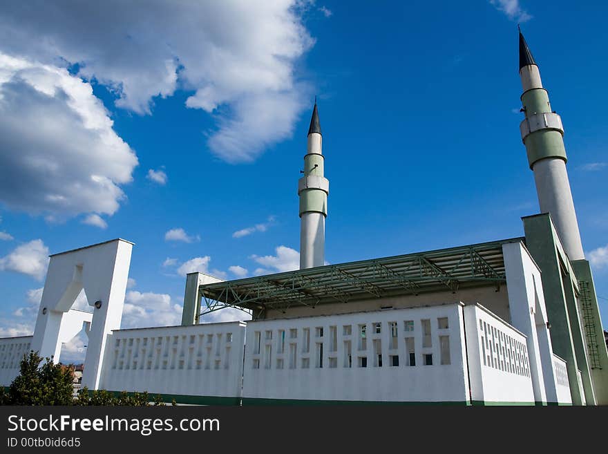 Mosque with two minarets on the sunny day under the blue sky