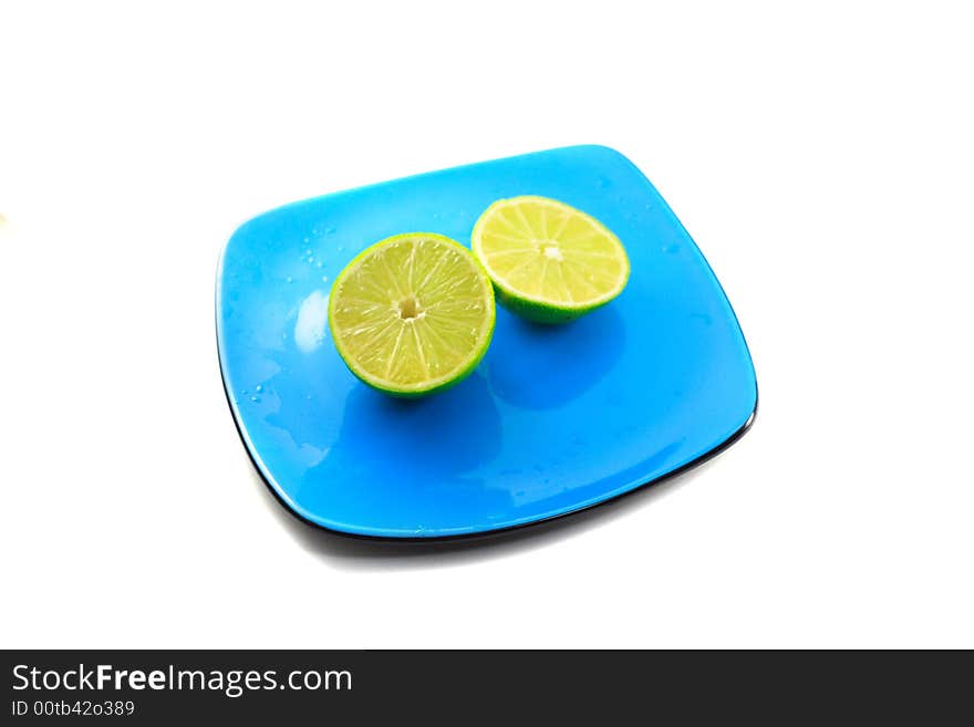 Limes on blue plate