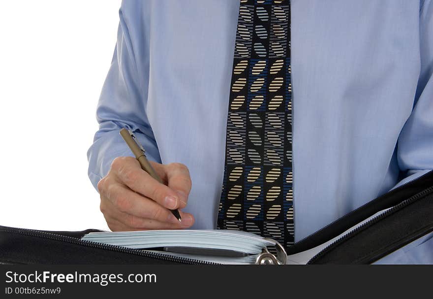 Business man writing in leather organizer