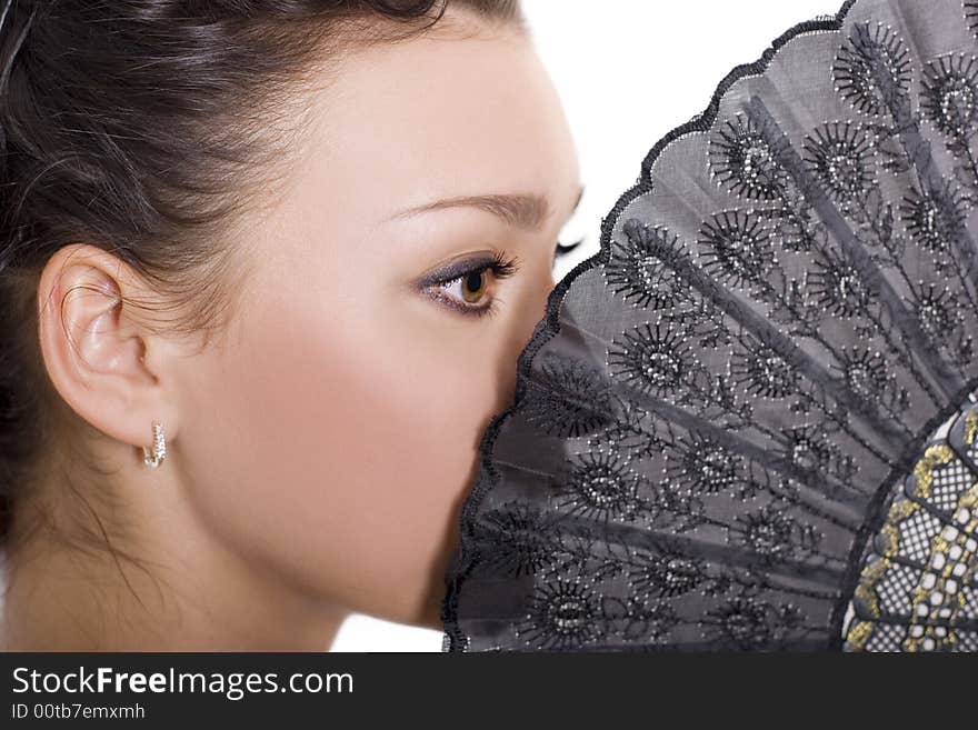 Cute brunette with a black fan over white. Cute brunette with a black fan over white