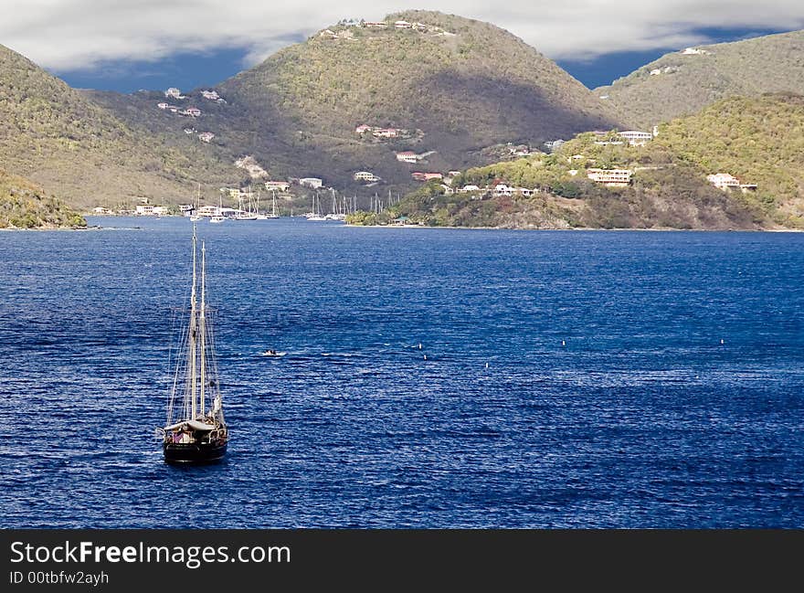 Lone Sailboat On Clear Water