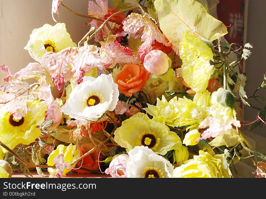 Worn out artificial flowers, left in the corner.