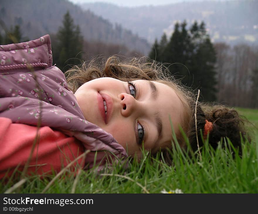 Little girl laying on the green grass. Little girl laying on the green grass