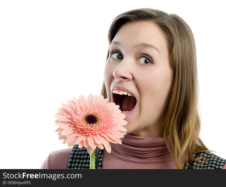 Grimacing girl truing to bite flower. Grimacing girl truing to bite flower