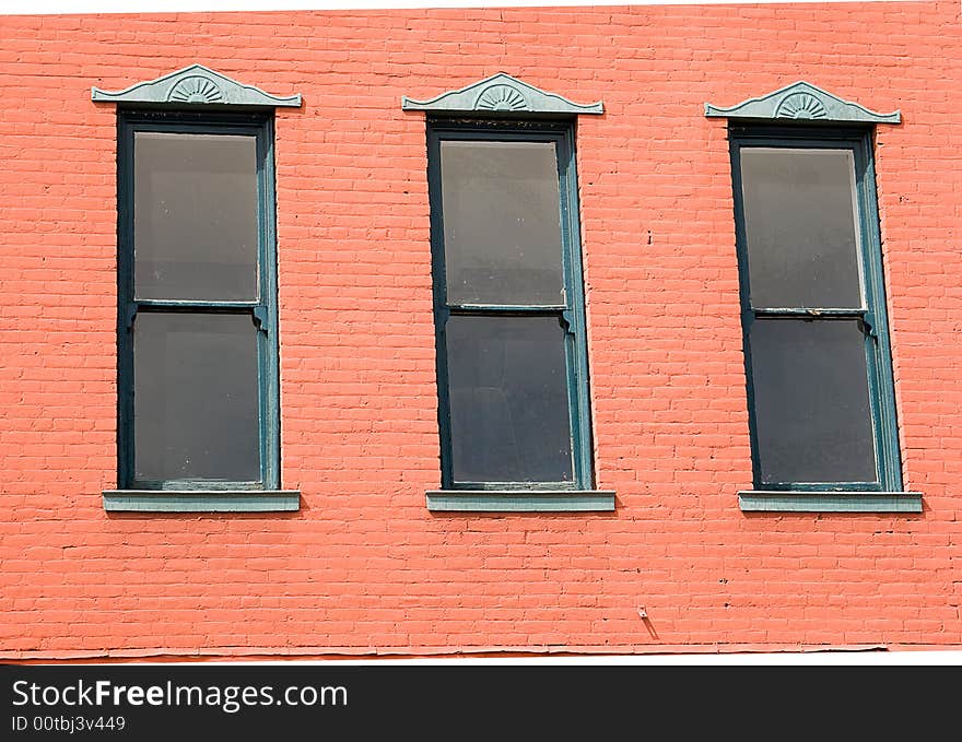 Three windows on wall of old building. Three windows on wall of old building