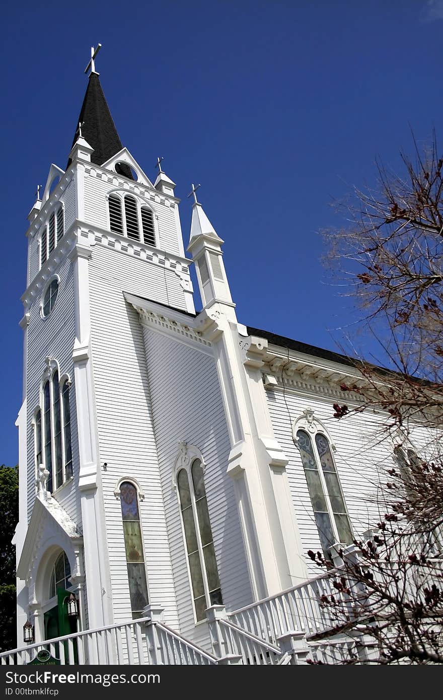 Wide angle shot of white church with blue sky background. Wide angle shot of white church with blue sky background