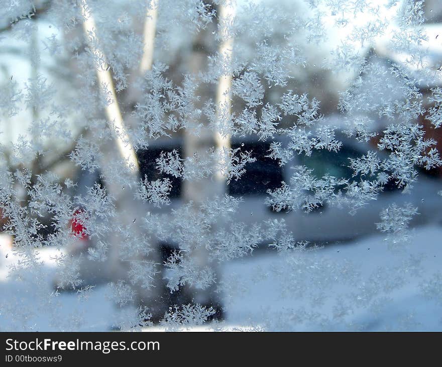 View through the window with snowflakes as a background. View through the window with snowflakes as a background