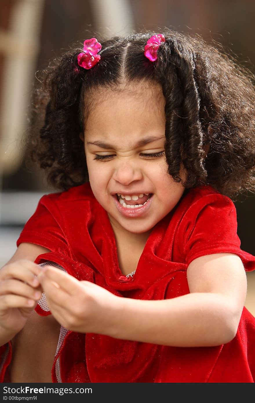 Beautiful multiracial child with afro hairstyle playing playing