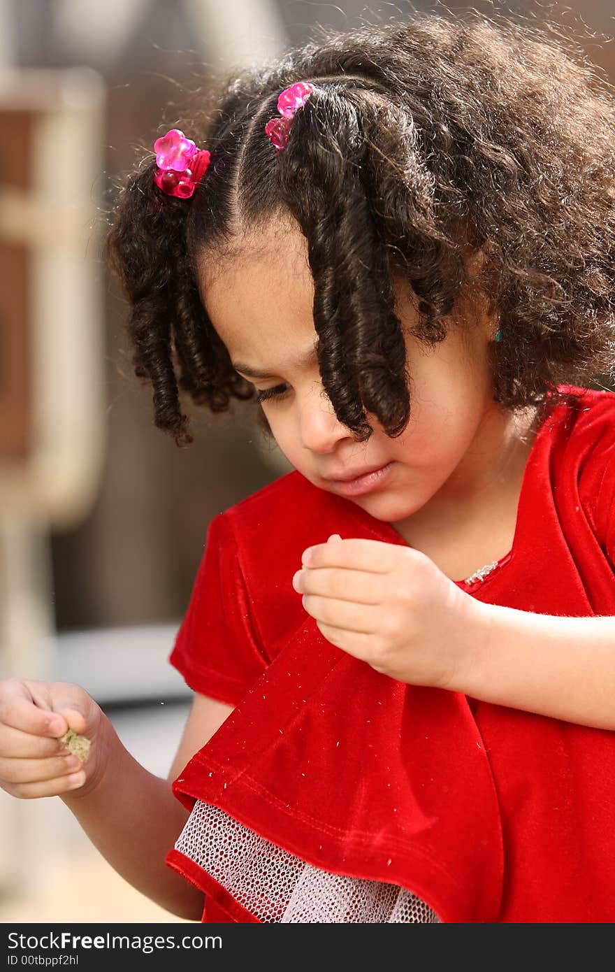 Beautiful multiracial child with afro hairstyle playing playing