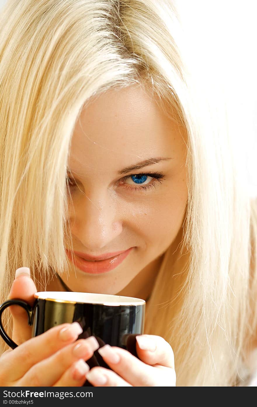 Portrait of the girl with an expressive sight and a mug of coffee. The isolated photo in studio on a white background. Portrait of the girl with an expressive sight and a mug of coffee. The isolated photo in studio on a white background.