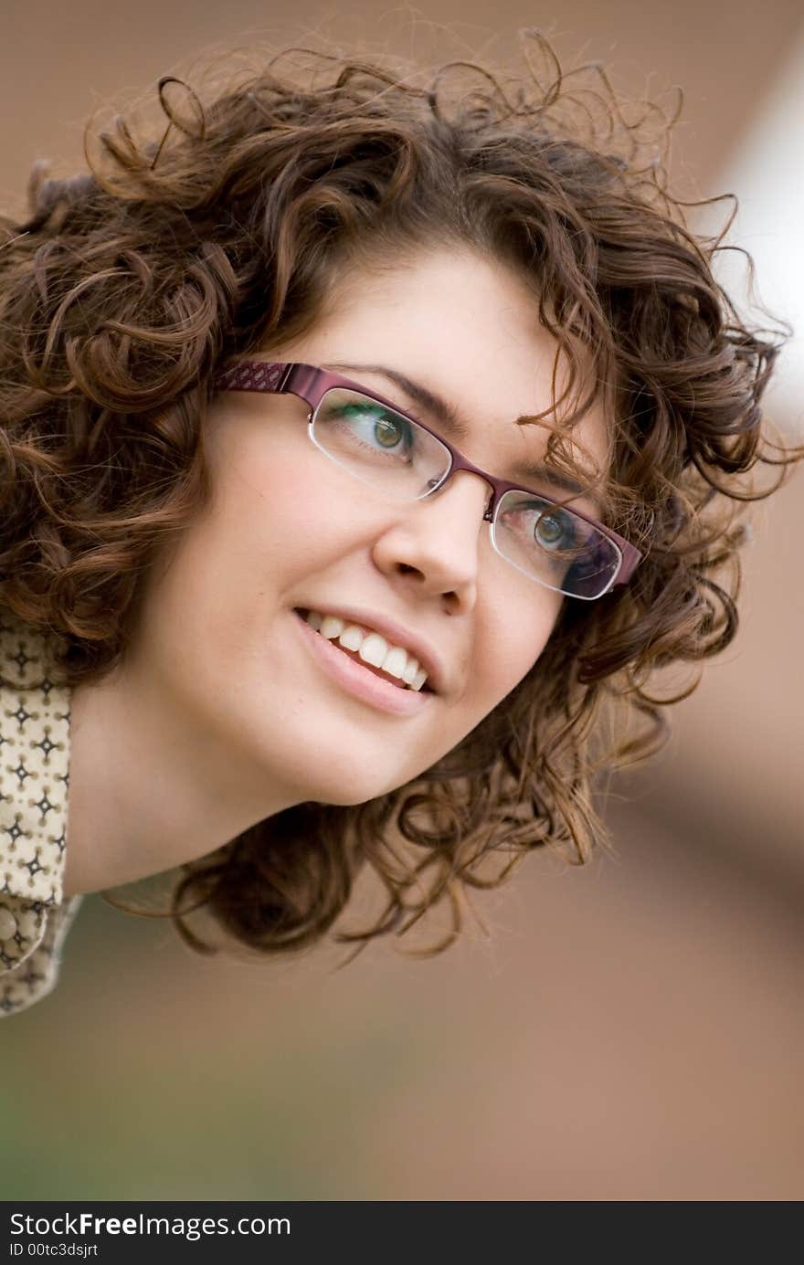 Portrait of the young beautiful woman on a brown background. Portrait of the young beautiful woman on a brown background