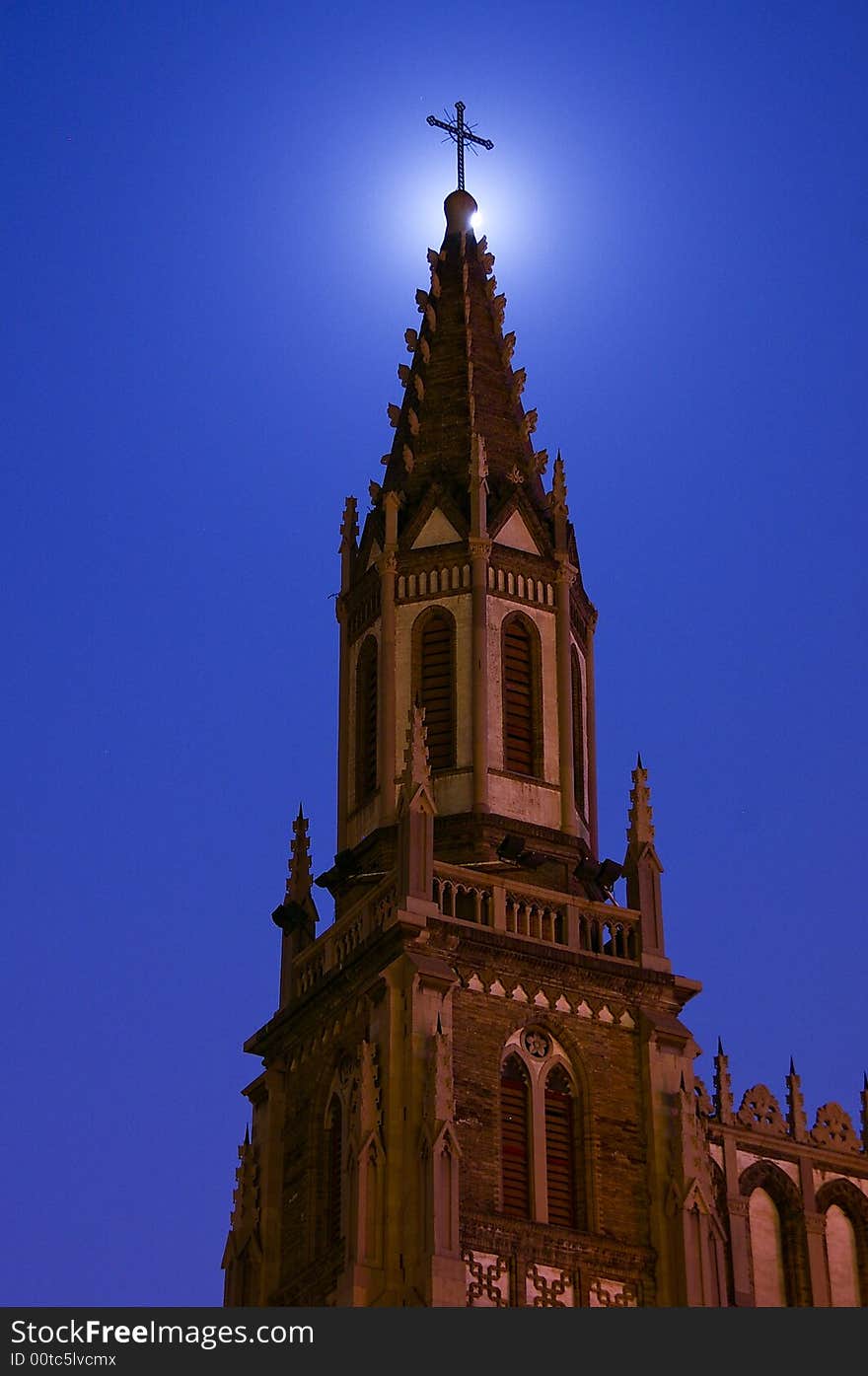 The Church in the night. The full moon are shading behind the church's Latin corss. The Church in the night. The full moon are shading behind the church's Latin corss.