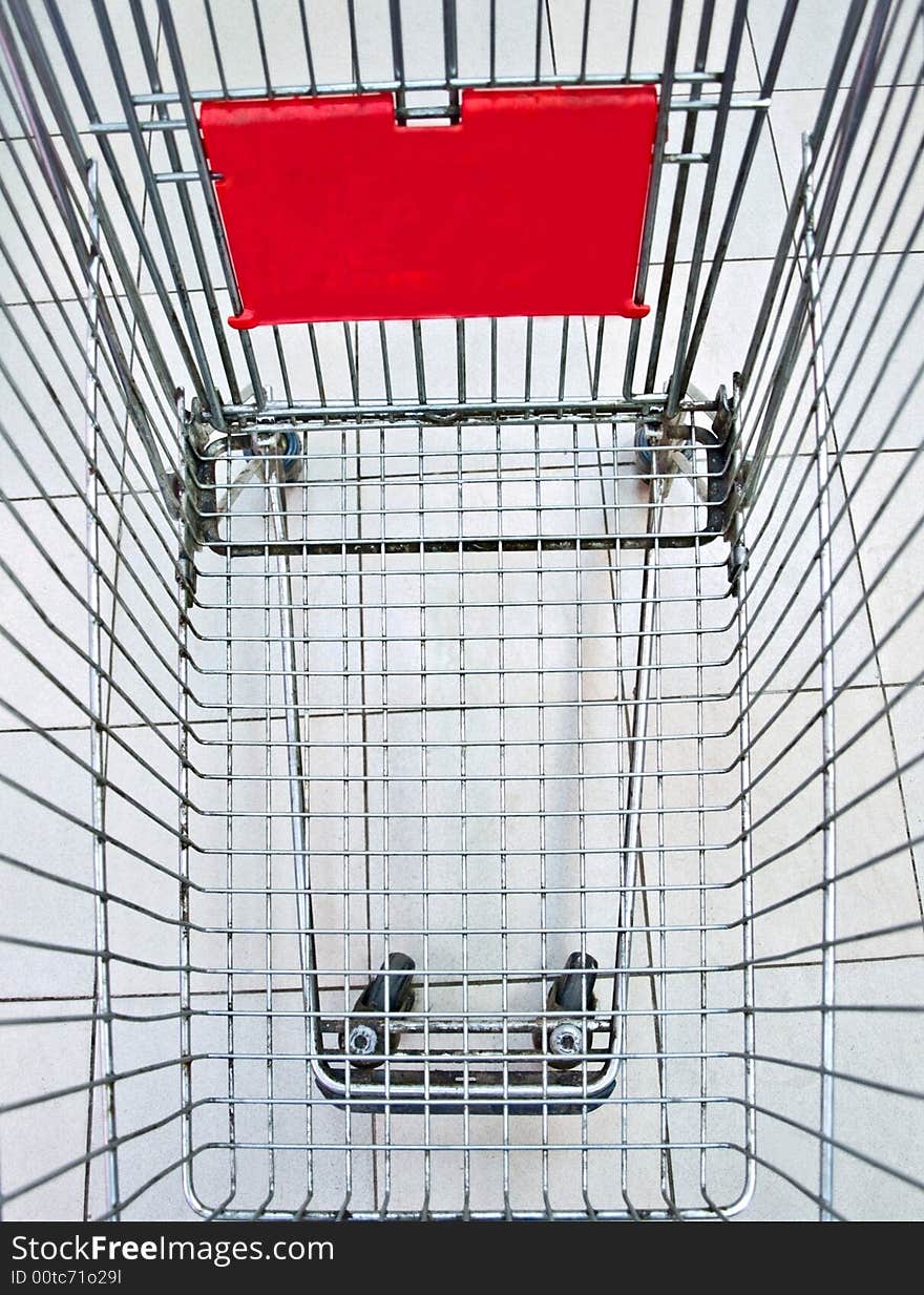 The empty shopping trolley cart. The empty shopping trolley cart