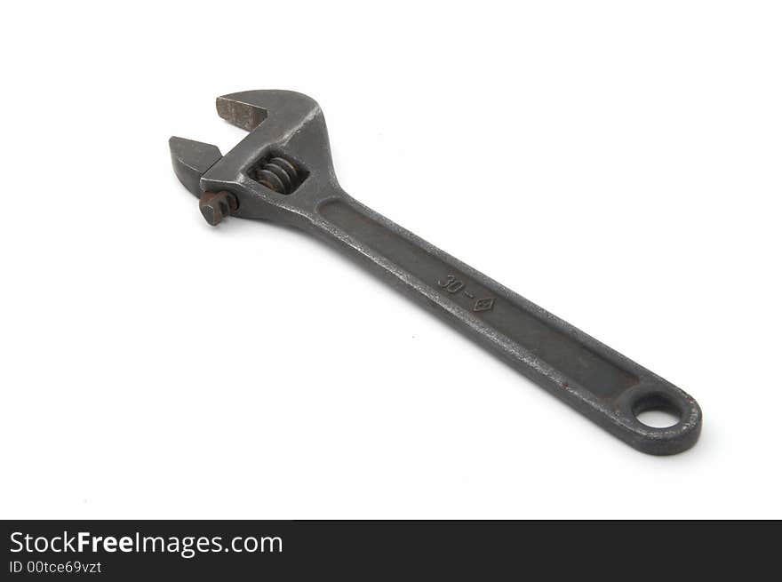 Iron adjustable spanner on a white background