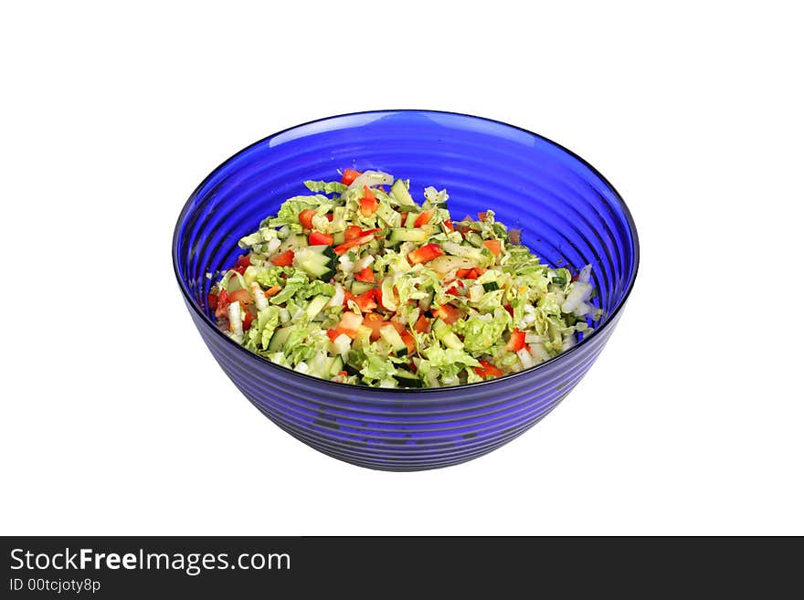 Vegetable Salad in blue salad bowl on white