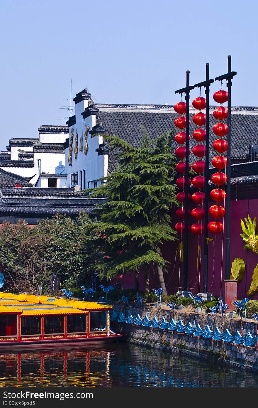 Beside the river, there are aged houses and some red lanterns. Beside the river, there are aged houses and some red lanterns.