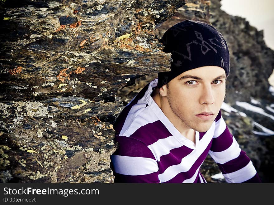 Young man portrait in casual clothing on the rocks. Young man portrait in casual clothing on the rocks