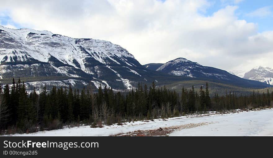 A rugged snow covered mountain in the rocky mountain range, in Jasper, Alberta. A rugged snow covered mountain in the rocky mountain range, in Jasper, Alberta