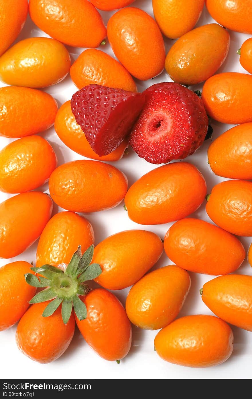 Many kumquats and two half strawberry. Many kumquats and two half strawberry