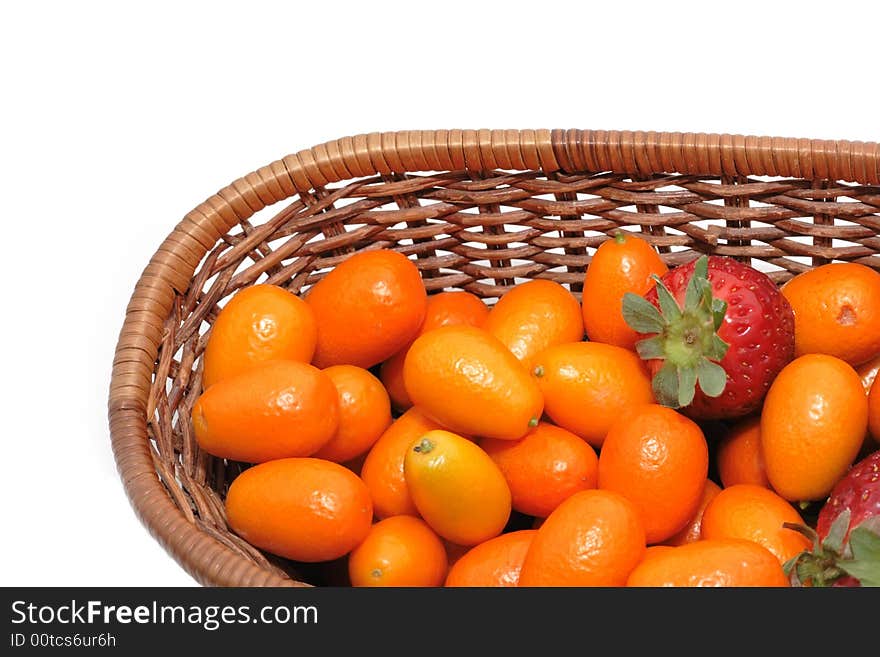 A lot of kumquats and strawberry isolated on the white background. A lot of kumquats and strawberry isolated on the white background