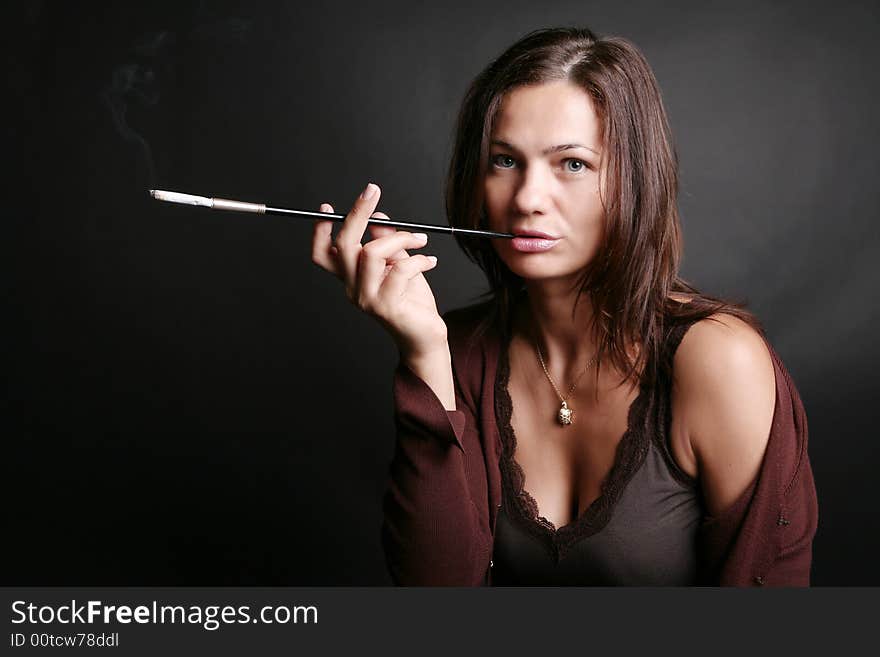 Portrait of a smoking woman on black background. Portrait of a smoking woman on black background