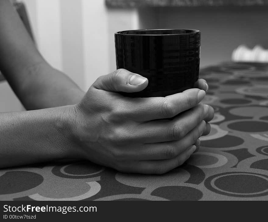 A couple of hands holding a coffemug. A couple of hands holding a coffemug