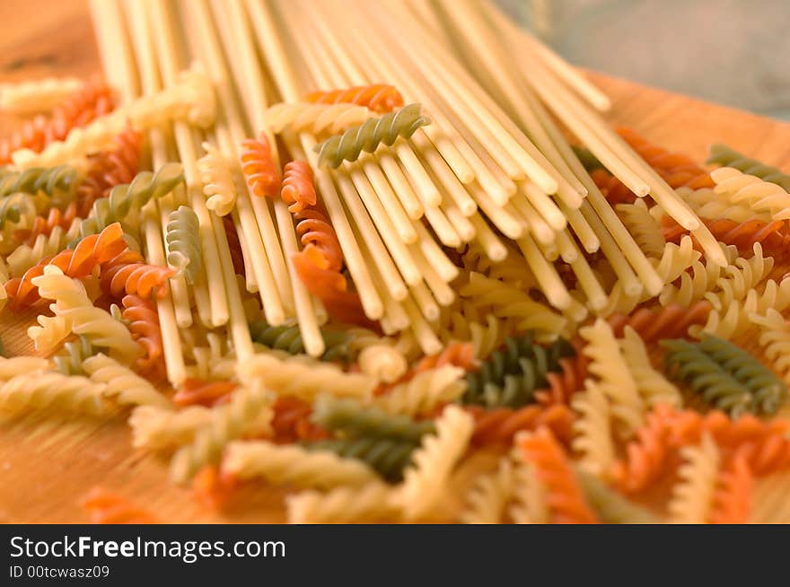 Raw colour pasta background on yellow cook-table. Raw colour pasta background on yellow cook-table