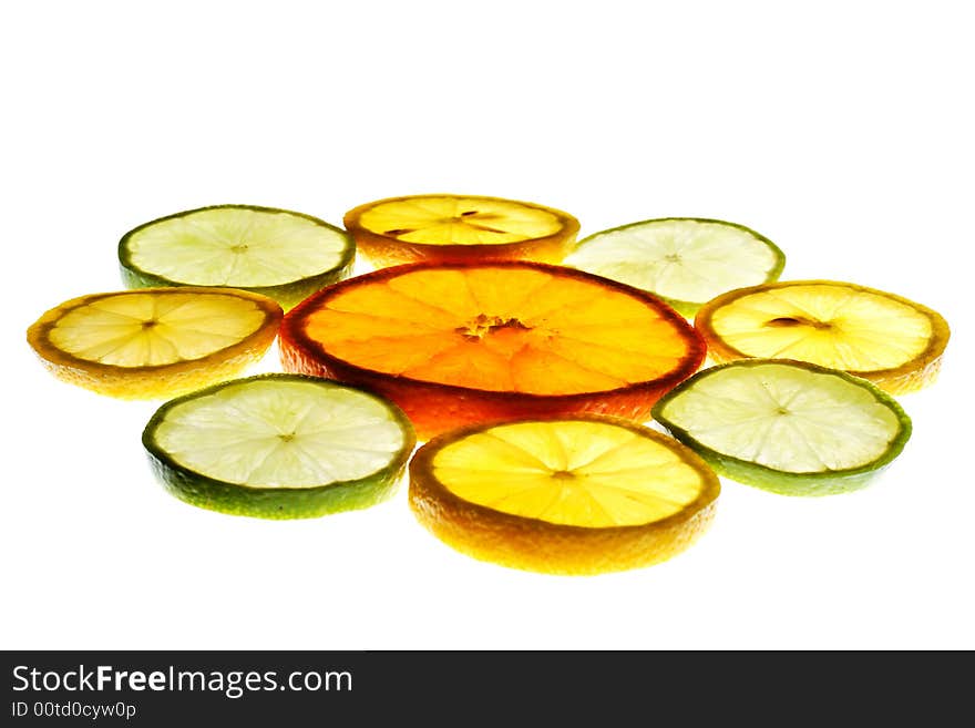 Orange slice surrounded with lemon and lime slices isolated on white background