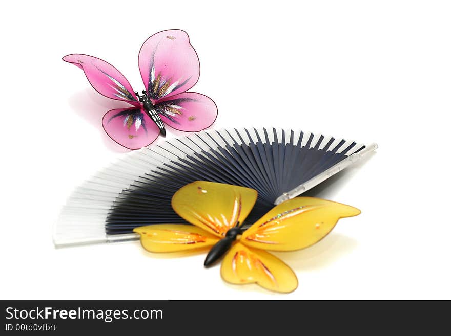 The artificial, plastic butterfly on a fan, focus on distant butterfly