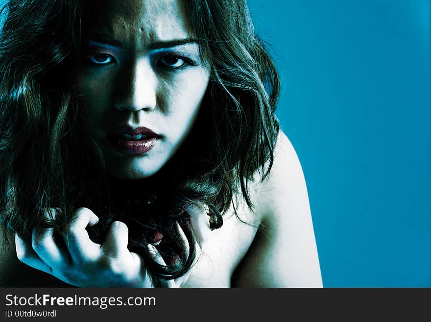 Young chinese girl on a blue background. Young chinese girl on a blue background