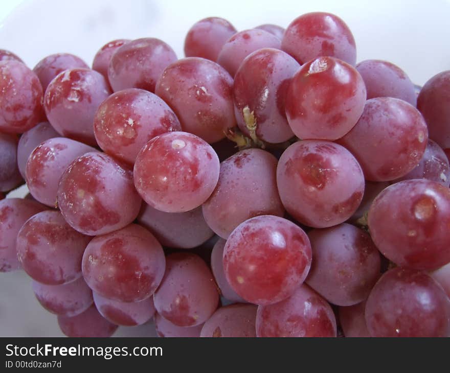 Red grapes on a white background