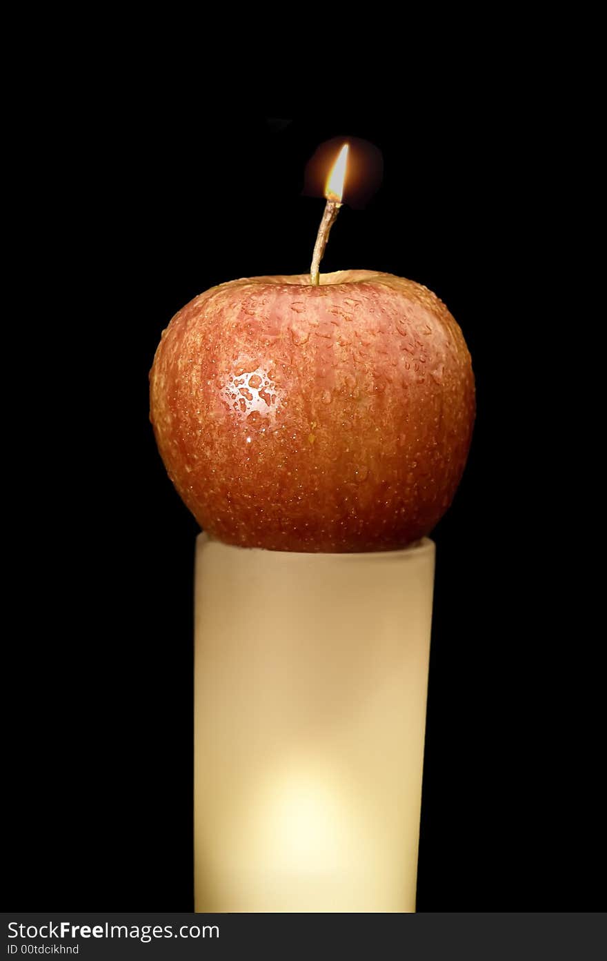 Wet apple burning ling a candle