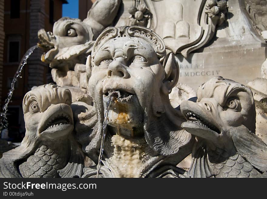 Close-up on a fountain in the city square in front of the Roman Pantheon. Close-up on a fountain in the city square in front of the Roman Pantheon