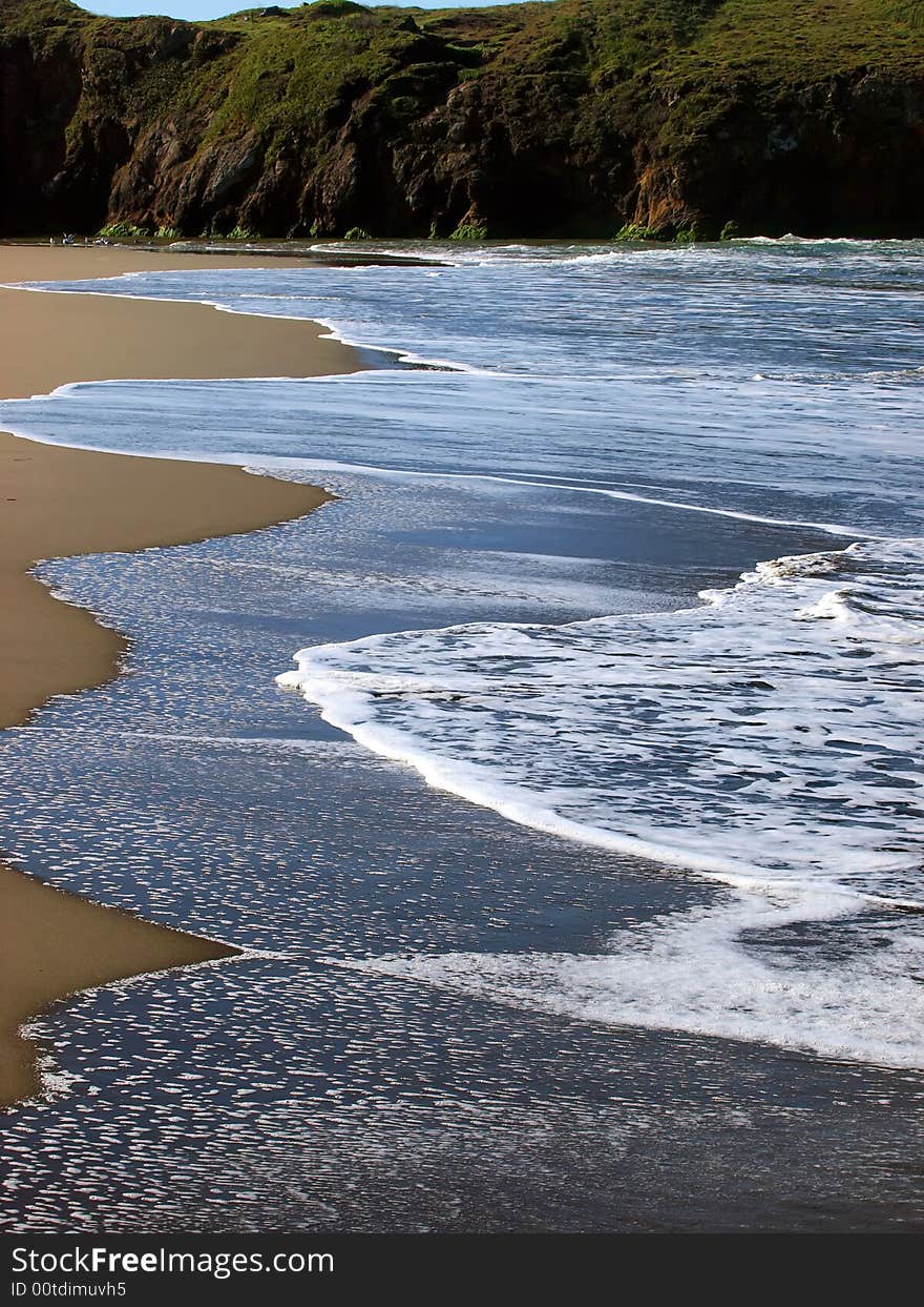 Receding wave on beach