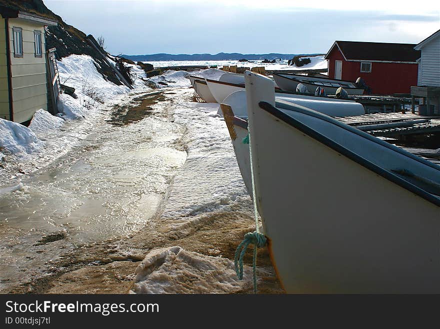 Icy winter wharf where the fishing boats are stored in Twillingate, Newfoundland. Icy winter wharf where the fishing boats are stored in Twillingate, Newfoundland