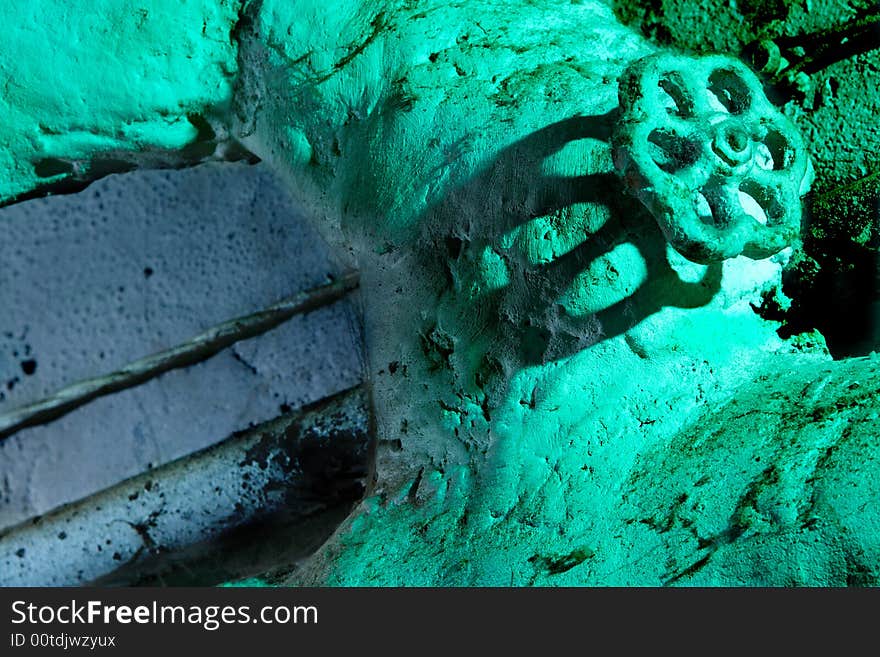 Old sewer pipe with valve and electric wire on whitewashing wall. Old sewer pipe with valve and electric wire on whitewashing wall