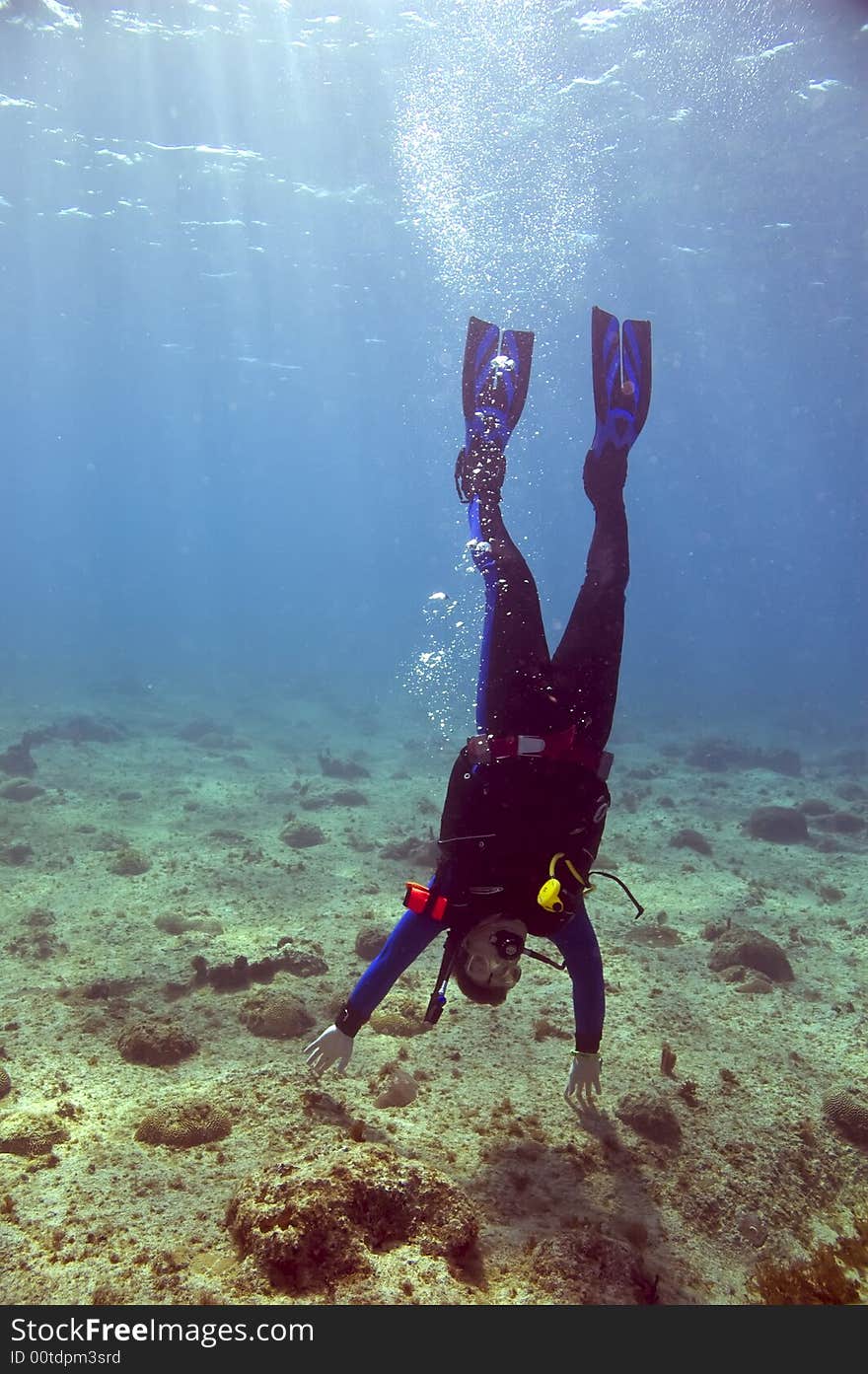 Scuba diver doing handstand