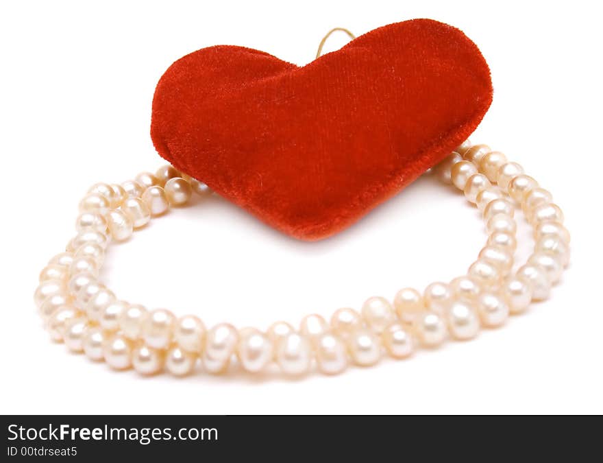 Beads and red heart isolated on white