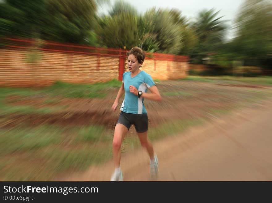 Female athlete in white training fast. Female athlete in white training fast.