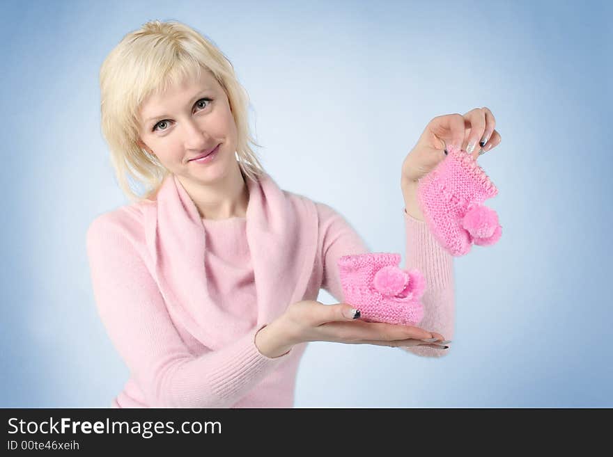 Young mother with baby's clothes. Young mother with baby's clothes